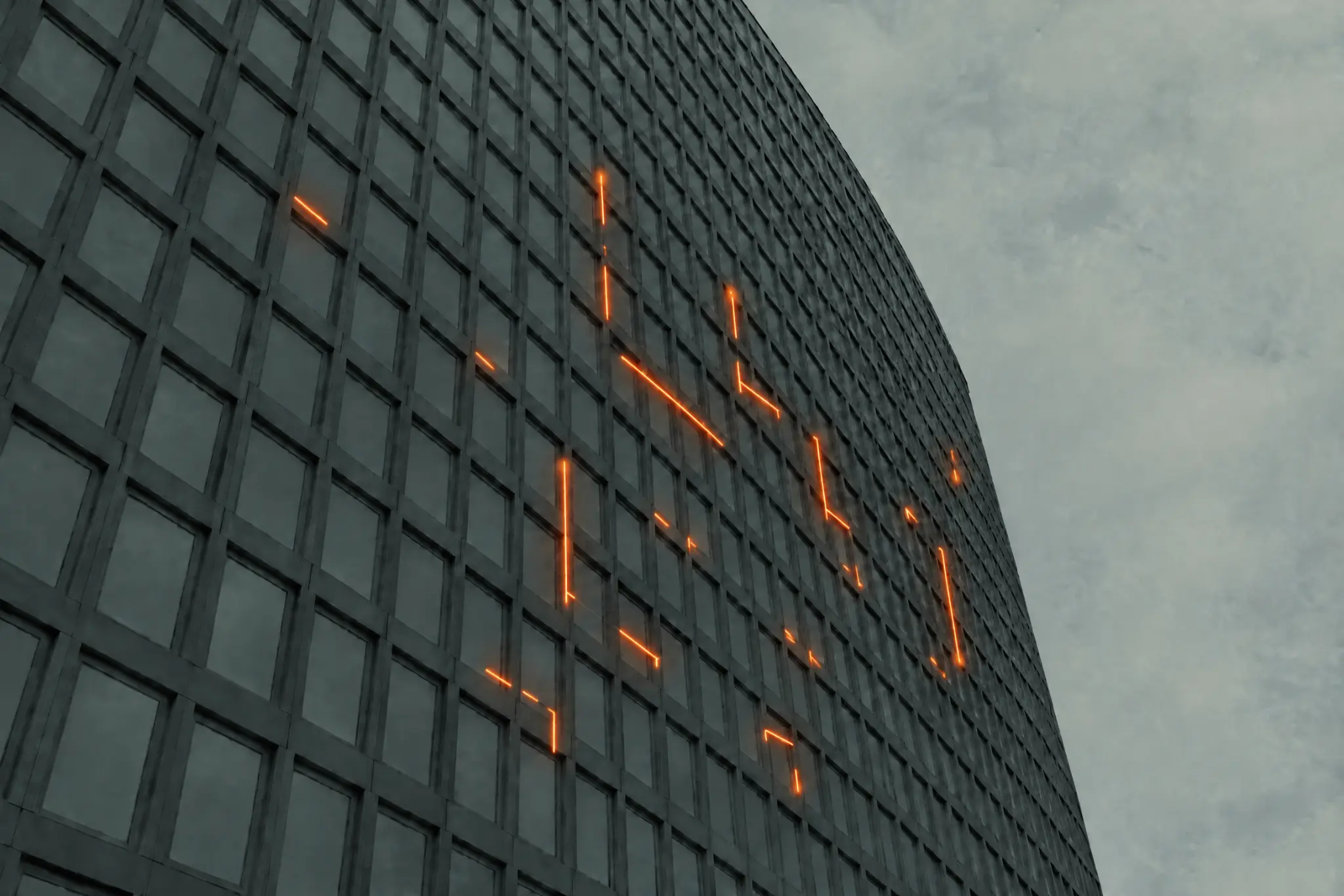 Modern curved building façade with intermittent orange illuminated seams